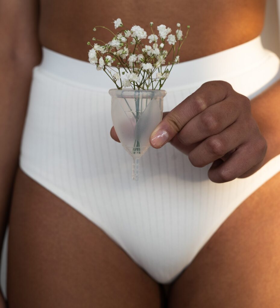 woman in white underwear holding baby's breath