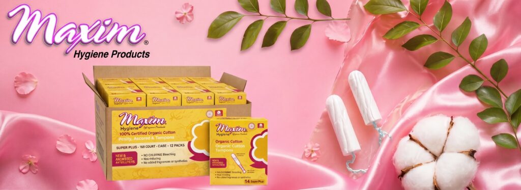 Maxim organic cotton tampons in regular, super, and super plus absorbencies displayed on a pink satin background with cotton, flowers, leaves, and product packaging.